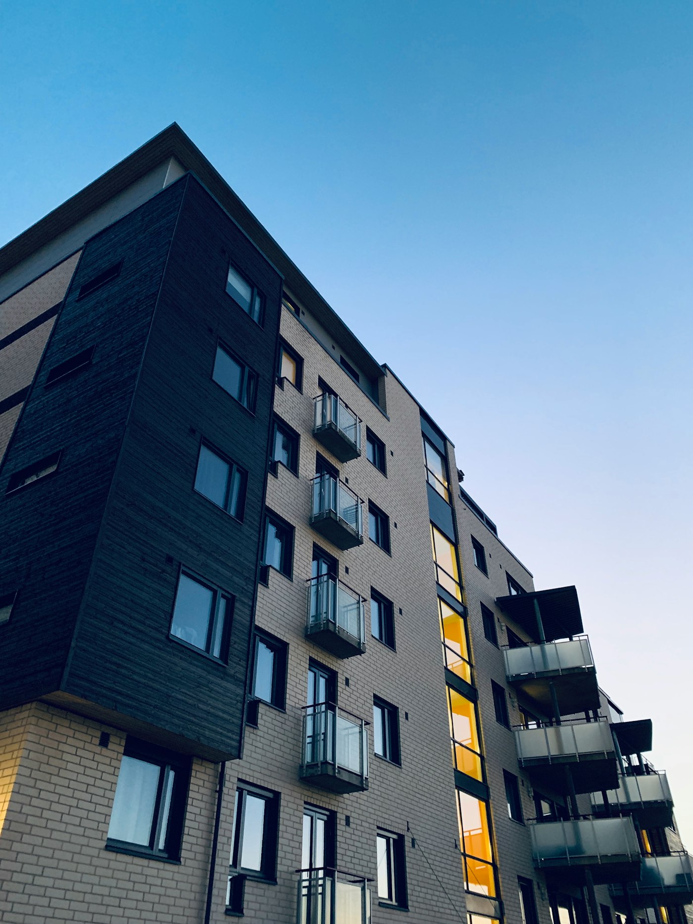 Modern multi-storey residential building with balconies, symbolizing a diversified real estate portfolio